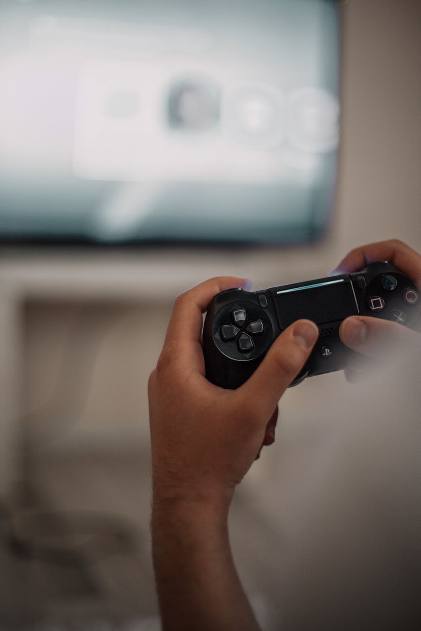 person holding black game controller